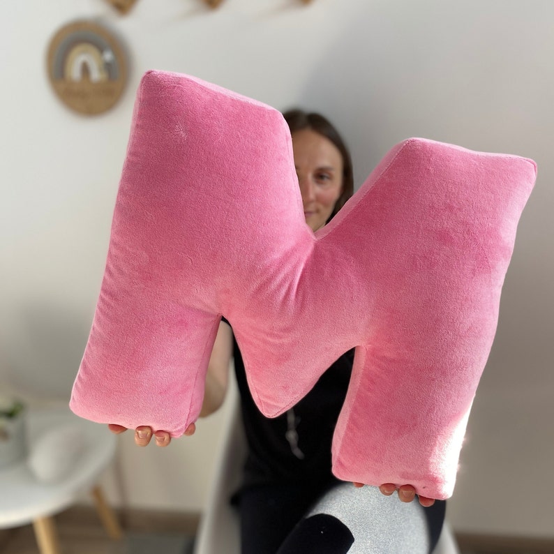 Pink velour decorative pillow in letter shape