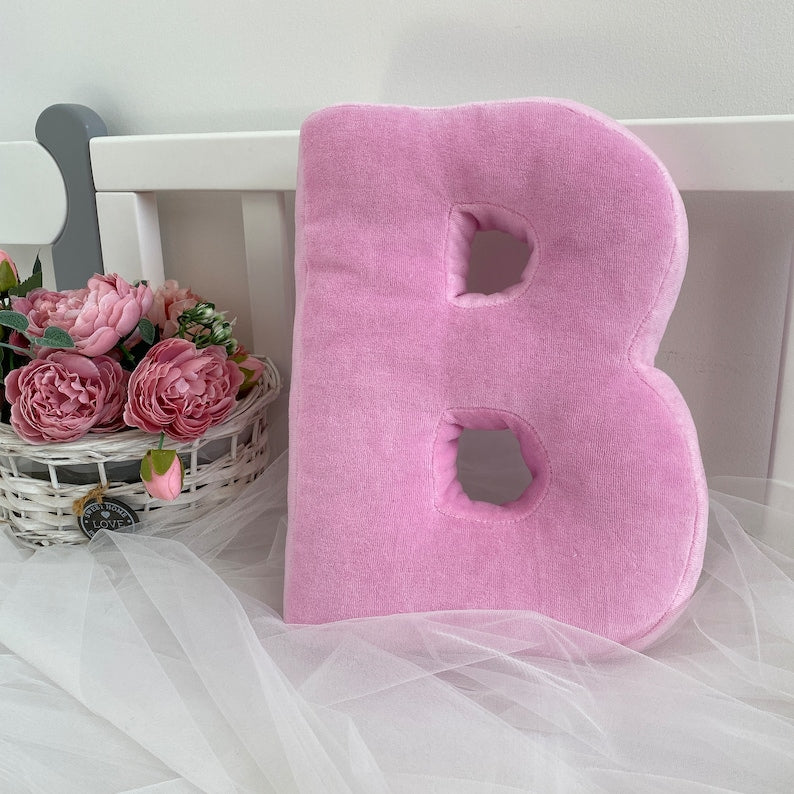 Pink velour decorative pillow in letter shape