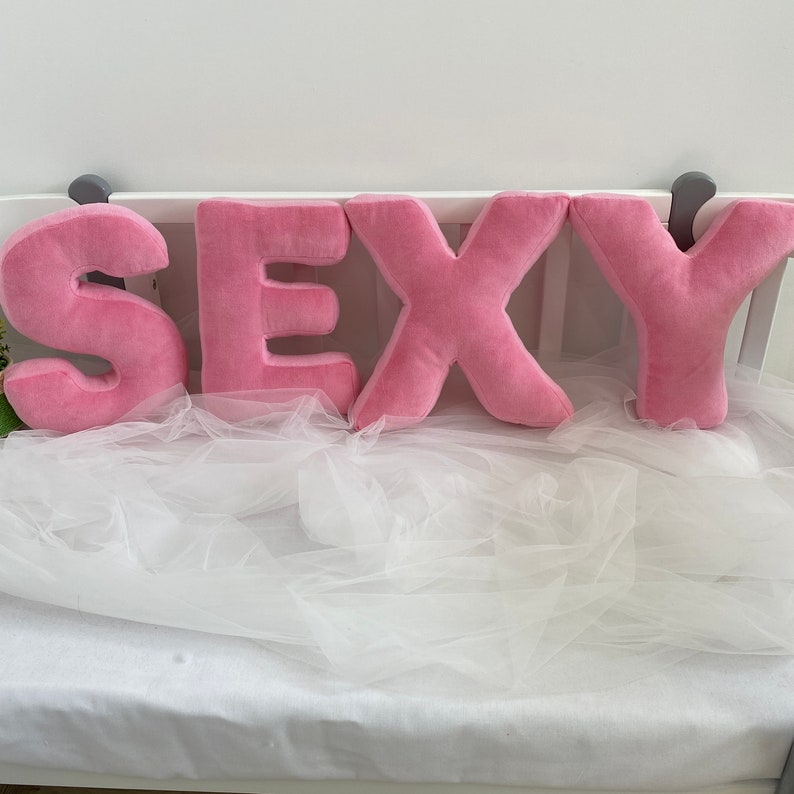 Pink velour decorative pillow in letter shape