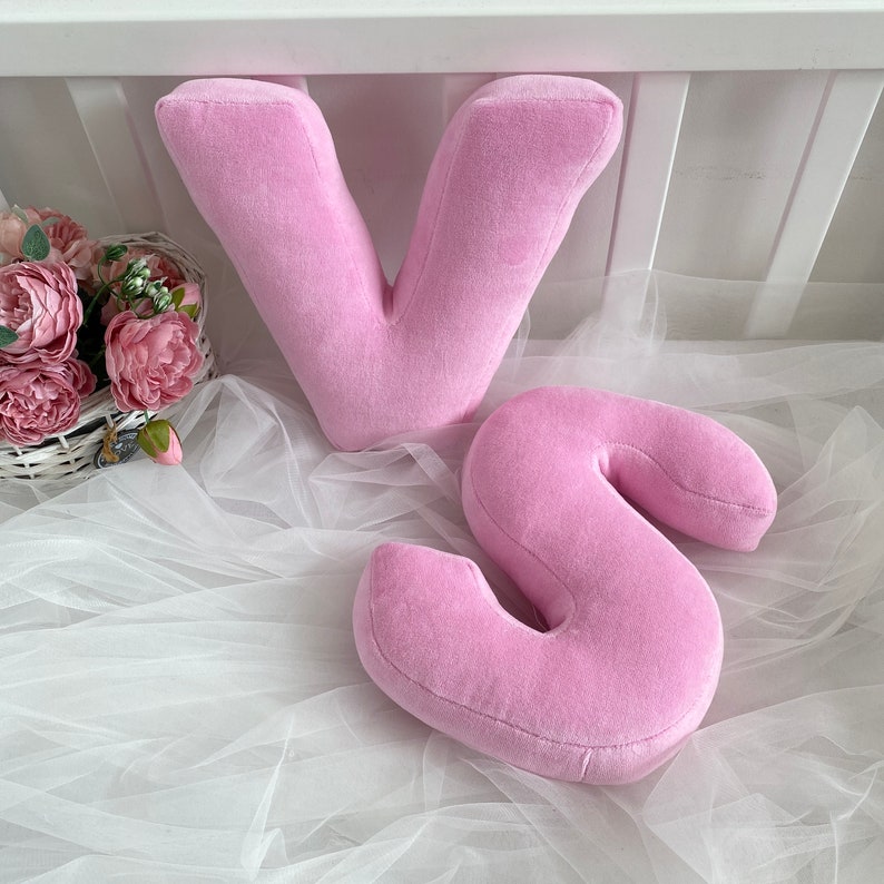 Pink velour decorative pillow in letter shape